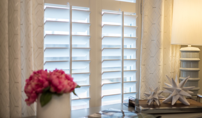 Plantation shutters by flowers in Phoenix